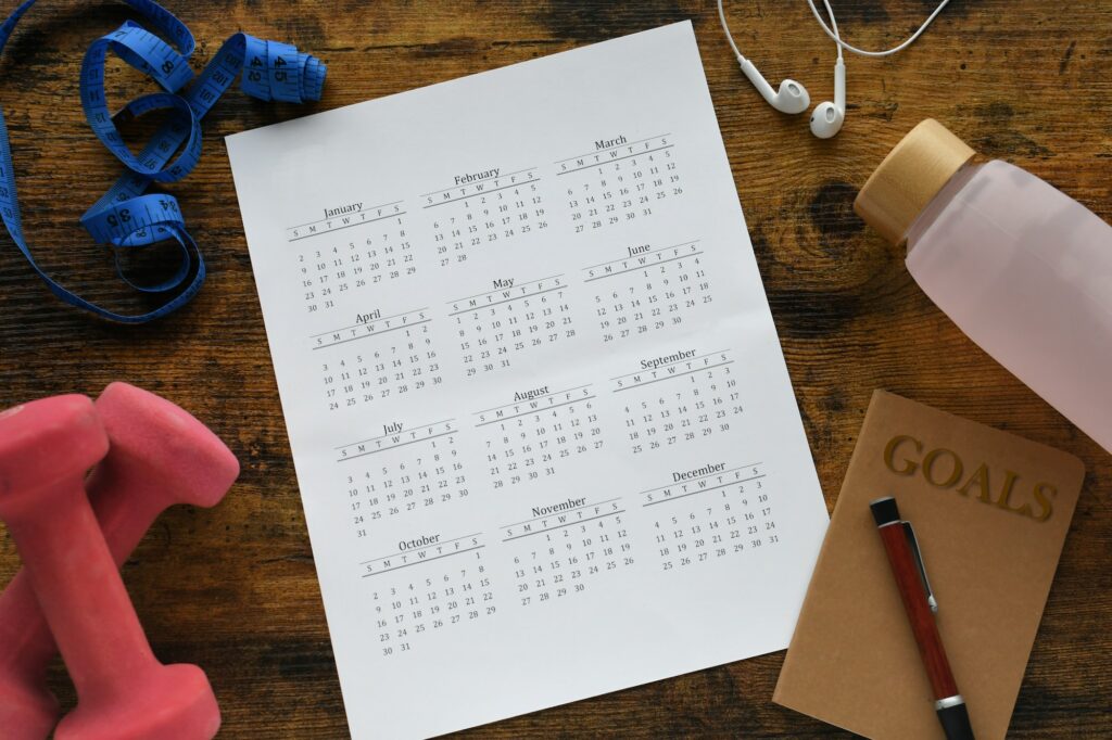 Calendar flat lay with health fitness items. New Year's resolution goals, new year new you