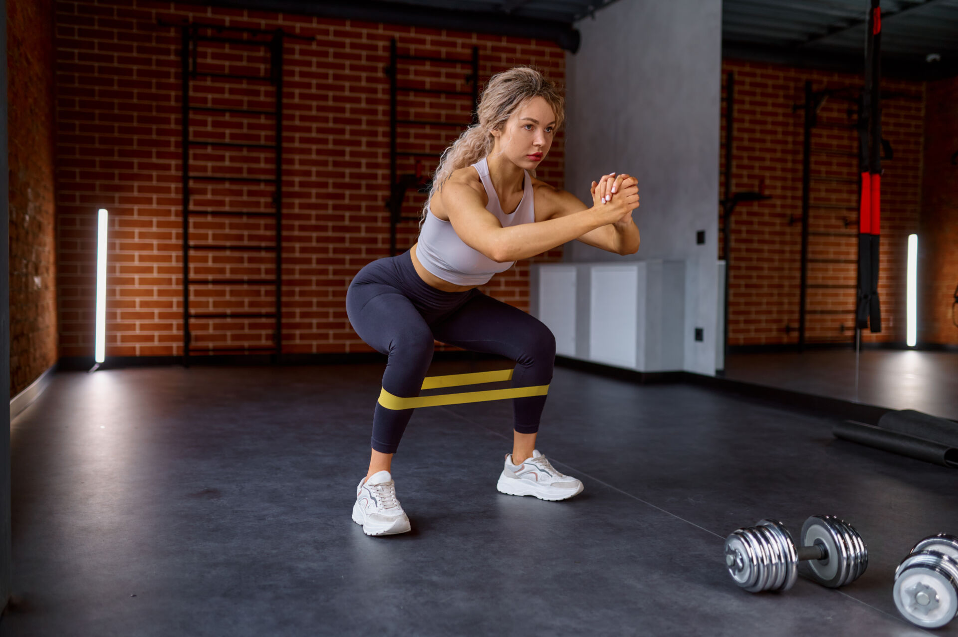 Woman training with fitness rubber band